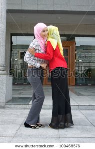 stock-photo-two-young-pretty-asian-muslim-business-woman-in-head-scarf-shake-hand-togethe-100468576